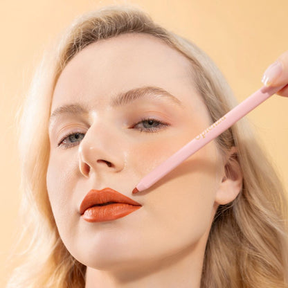 An elegant woman wearing and showcasing the vegan, luxury and cruelty free oplenza Define & Refine Lip Liner in the color Terracotta Kiss