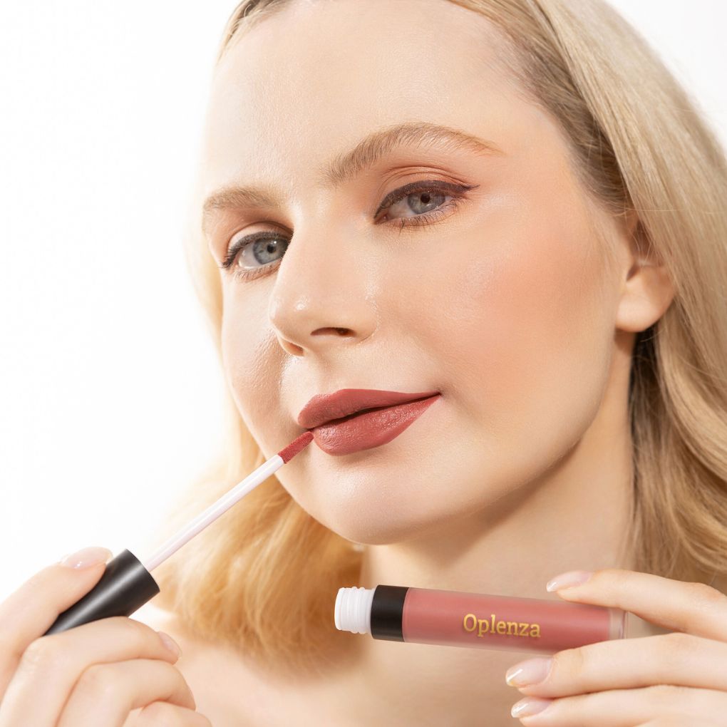 A Woman wearing and showcasing the elegant Oplenza Signature Velvet Liquid Lipstick in the color Twilight Rose