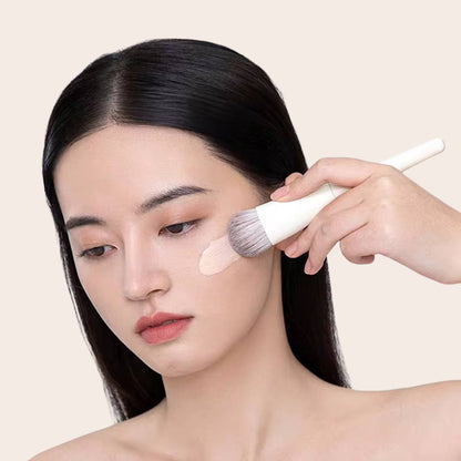 Woman using and showcasing Oplenza contouring brush.