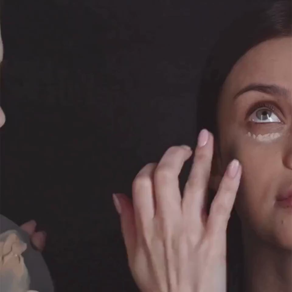 makeup artist applying oplenza Natural Finish Cream Concealer on a model